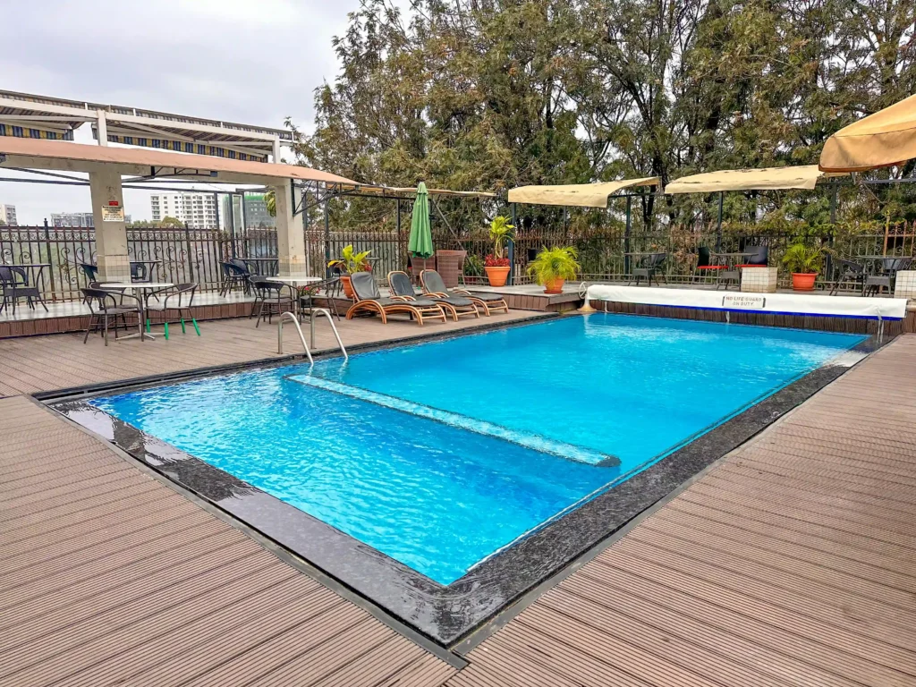 ooftop heated swimming pool at Clarence Hotel Nairobi with lounge chairs, shaded seating, and city views in Westlands.
